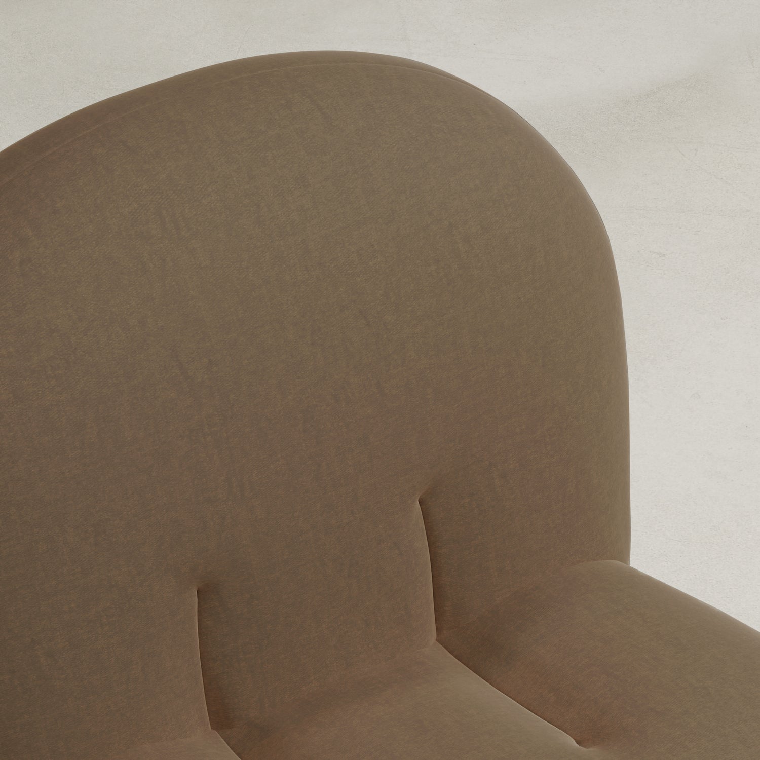 Close-up of the upper part of the Colette Chair, showcasing its rounded backrest, light brown fabric upholstery, subtle tufted details, and rich texture that elevates modern style against a plain, light background.