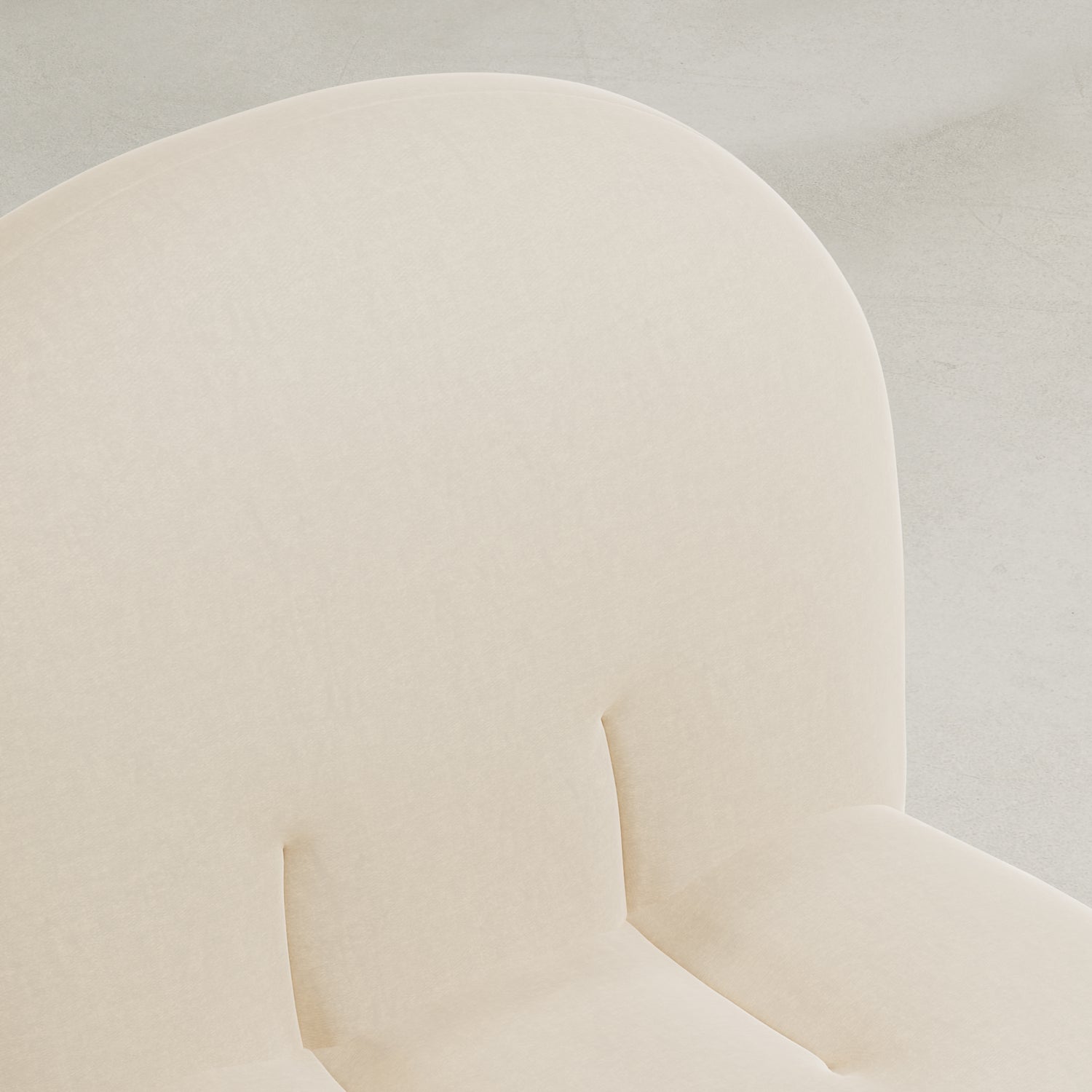 Close-up of the Colette Chair, featuring soft beige upholstery, a rounded backrest, and plush seat cushions that highlight its rich texture and contemporary style against a light neutral background.