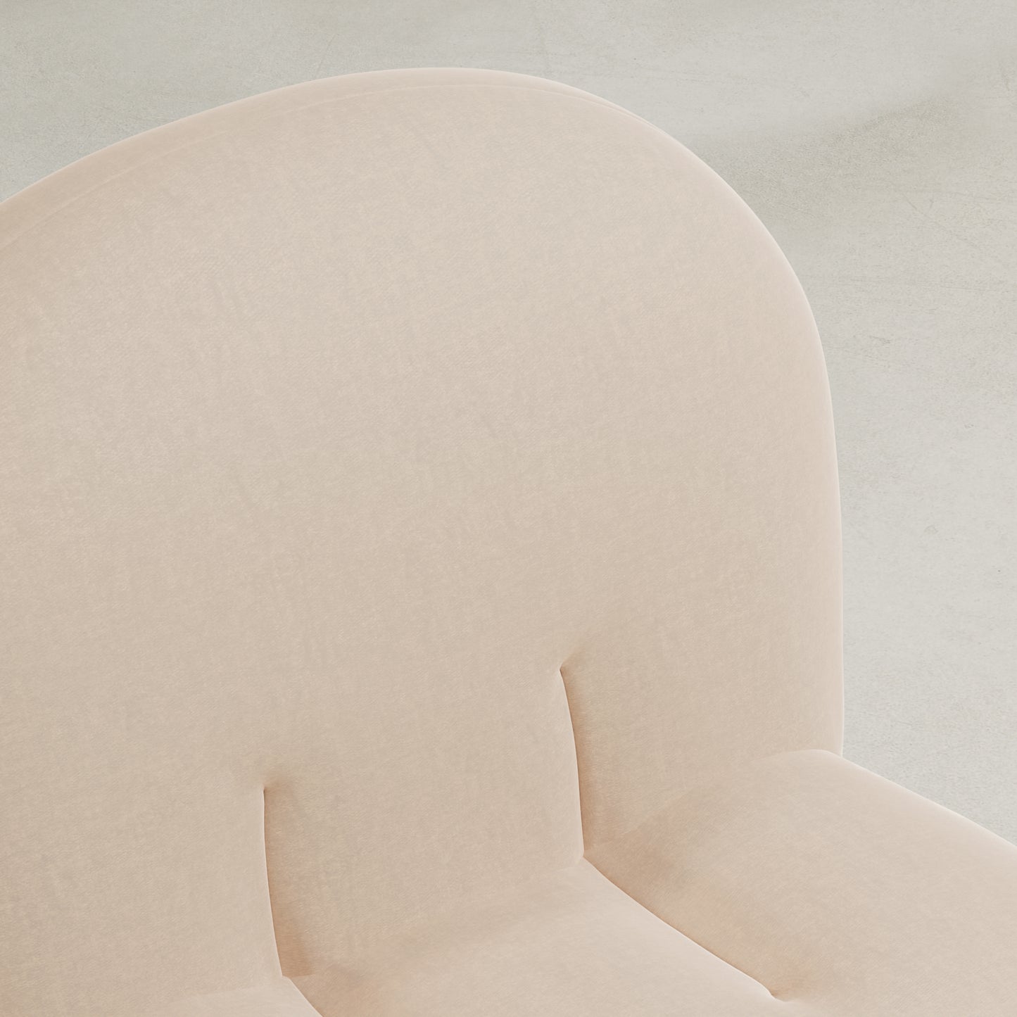 Close-up of the Colette Chair, featuring light beige upholstery, a rounded cushioned backrest with subtle tufting, and plush cushions that highlight its rich texture against a neutral background.