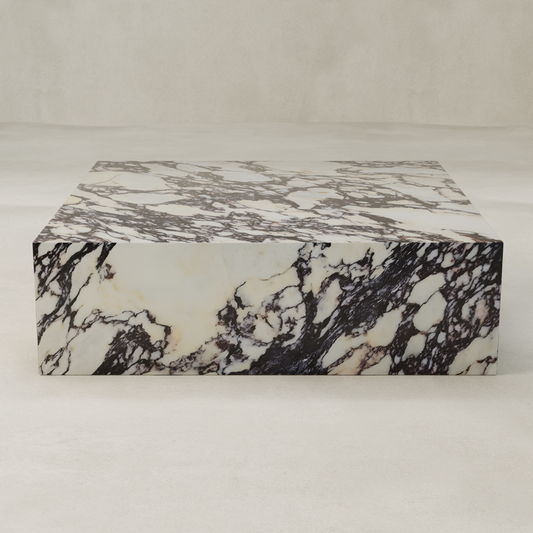 The Calacatta Coffee Table features polished Calacatta Viola marble with striking black and white veining, bringing sophisticated style to any space when placed against a light, neutral background.