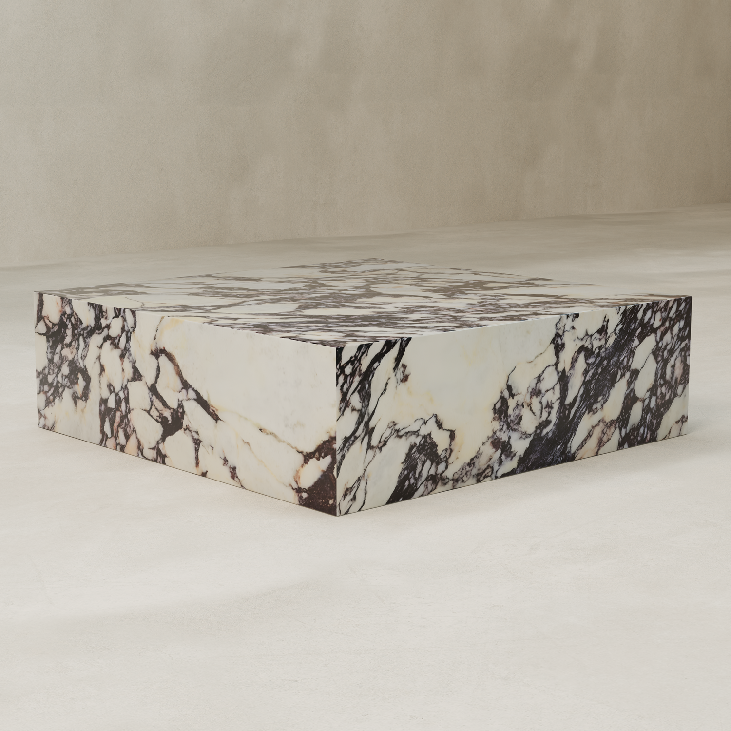 The Calacatta Coffee Table XL is a low, square table crafted from luxurious Calacatta Viola marble with striking black and brown veins, displayed on a light textured floor against a beige wall.