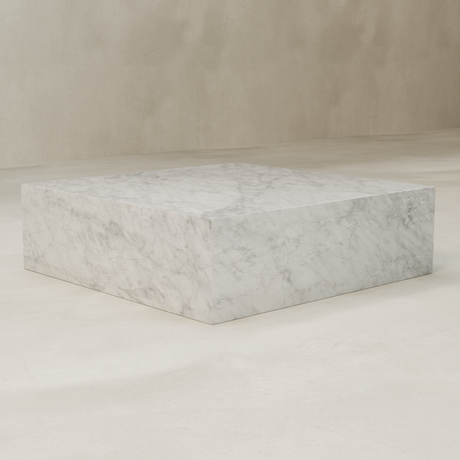 The Griselle Marble Coffee Table XL, with its large rectangular shape and gray veining, sits elegantly on a light floor against a beige wall.