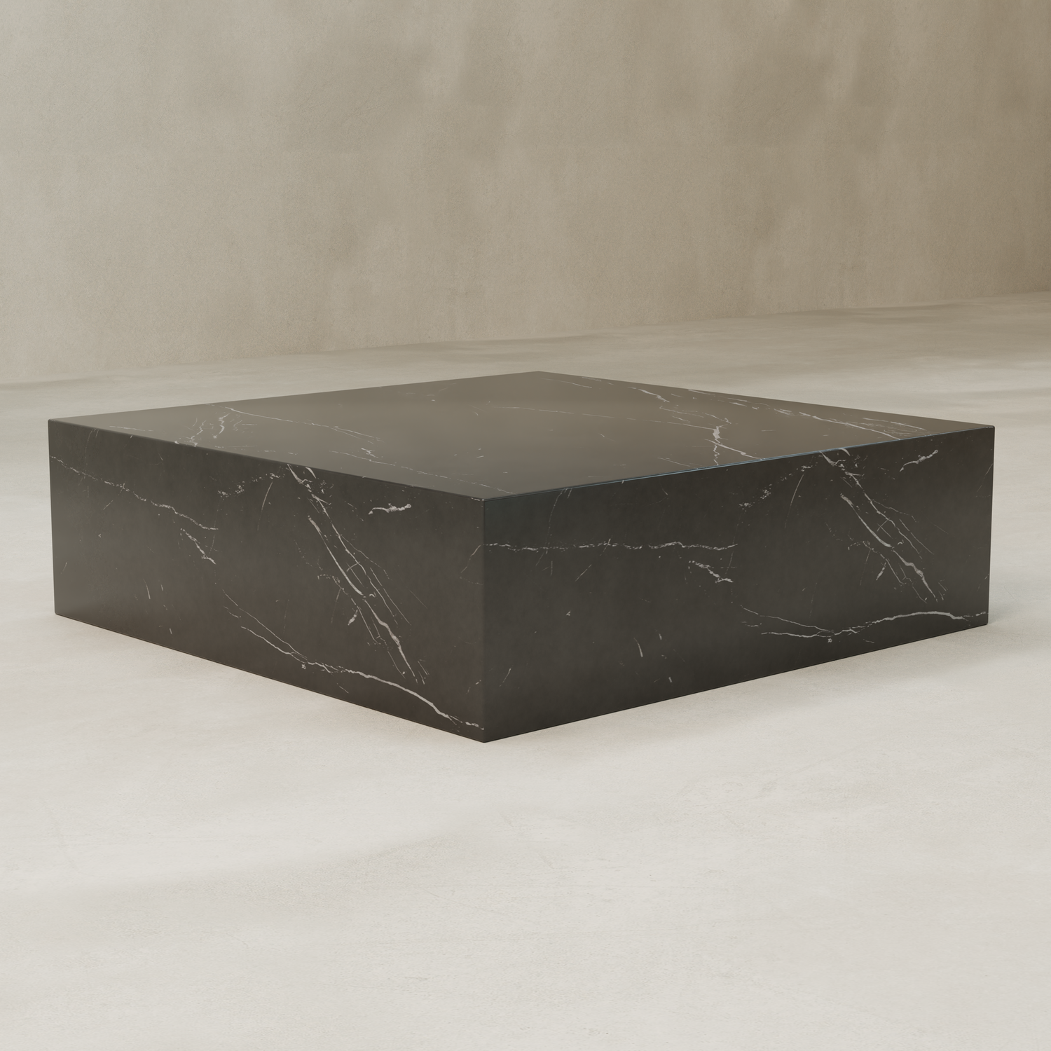 The Obscara Coffee Table XL features a large, square black marble top with white veining and a polished surface. Its solid, minimalist design makes it an elegant modern accent piece for any room.