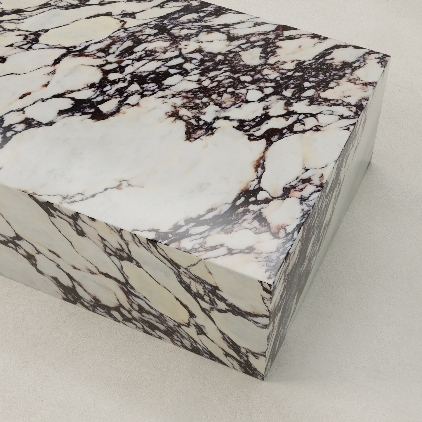 The Calacatta Coffee Table features a polished rectangular block of Calacatta Viola marble with a white base and dark brown, beige, and black veins—perfect for adding sophisticated style to any decor.