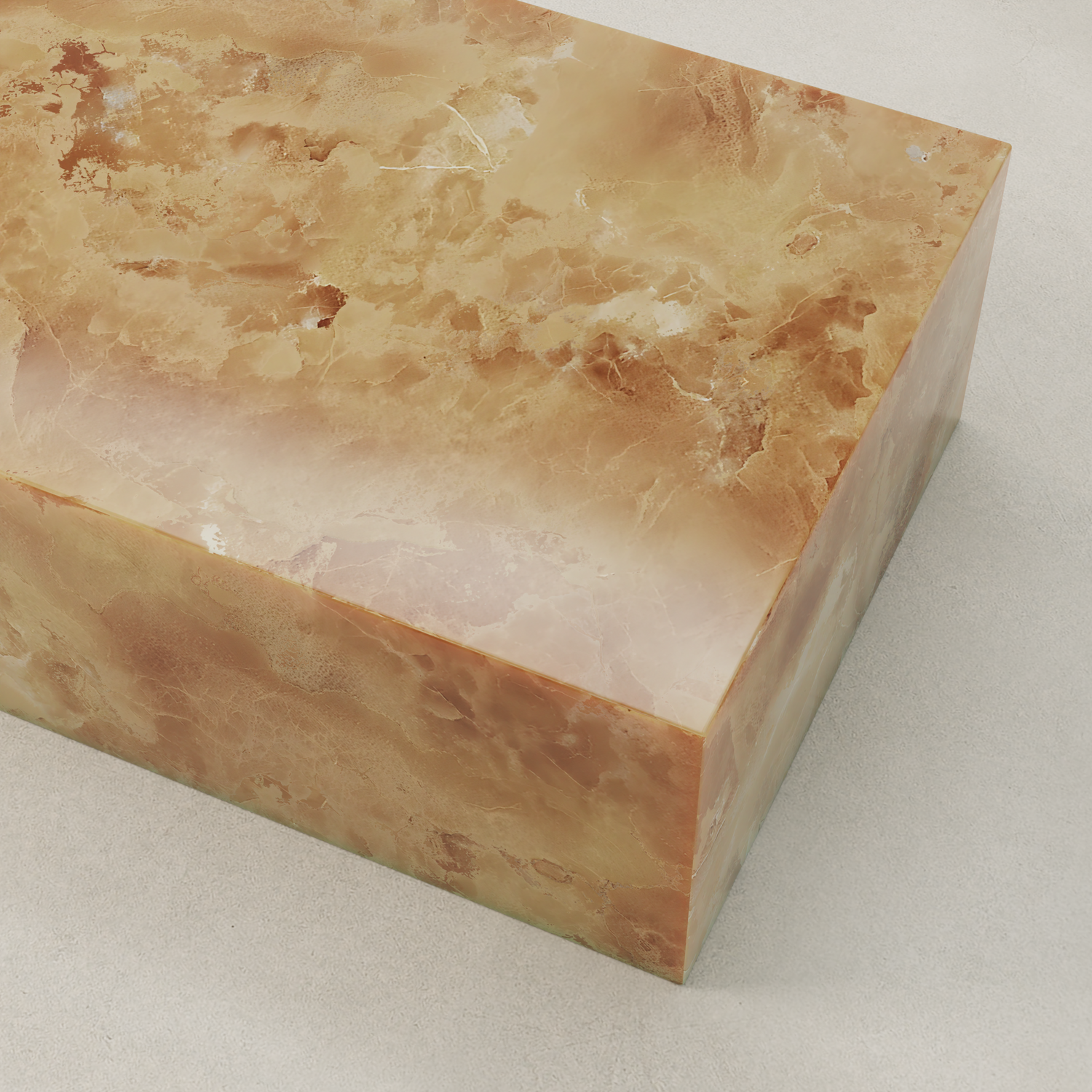 A sculptural cube of polished orange and cream-colored onyx sits on a smooth, light surface. The stone’s natural, cloudy patterns and glossy finish bring organic elegance to the Ambeline Onyx Coffee Table centerpiece.