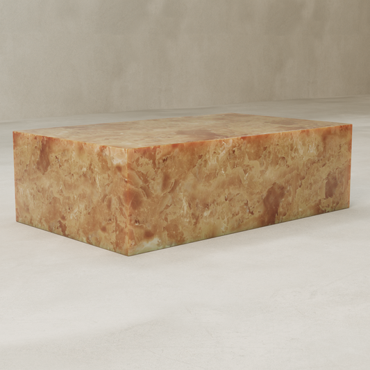The Ambeline Onyx Coffee Table showcases a polished marble surface in warm brown, tan, and gold with rust-hued marbling, bringing organic elegance to any space. It rests on a light floor against a neutral beige wall.