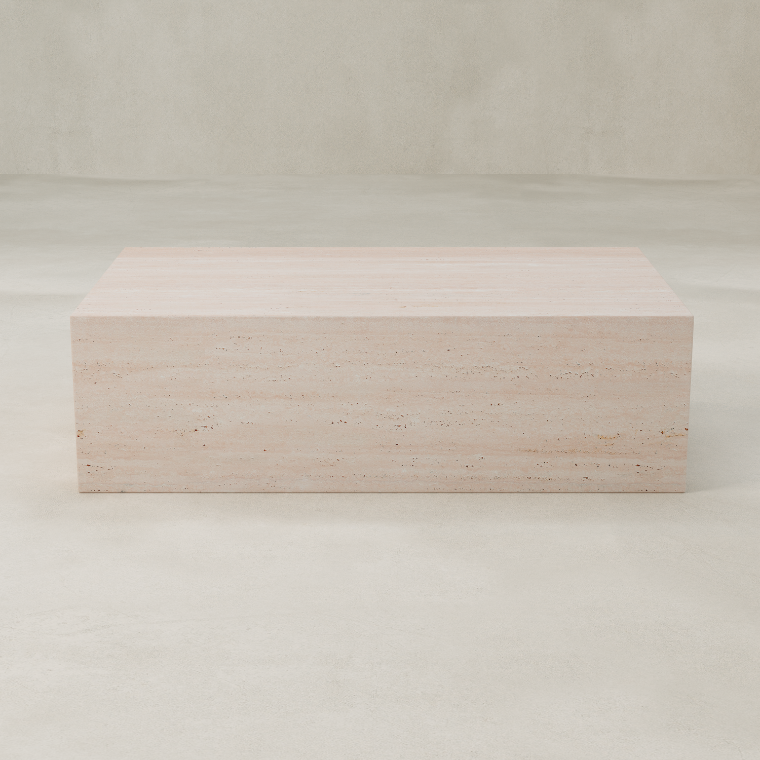 The Alessia Coffee Table is a rectangular, light beige travertine piece with a smooth surface and minimalist design, exuding timeless elegance and sculptural presence on a pale, seamless background.