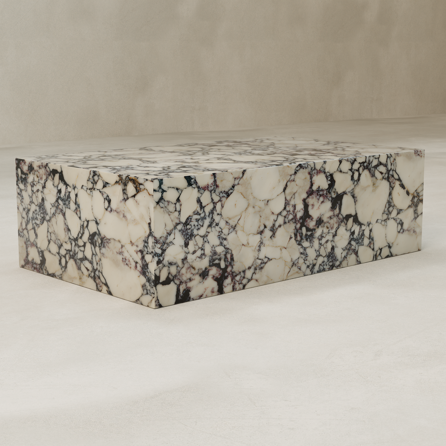 The Azurine Marble Coffee Table, featuring a modern rectangular design and striking cream and black veining, sits on a smooth, light-colored floor against a neutral background.