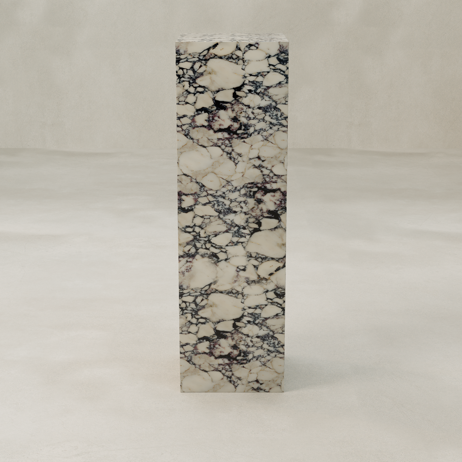 The Azurine Tall Tower Plinth features marble elegance with a cream background and dark, intricate veins. It stands on a smooth, light gray surface against a plain, textured wall.