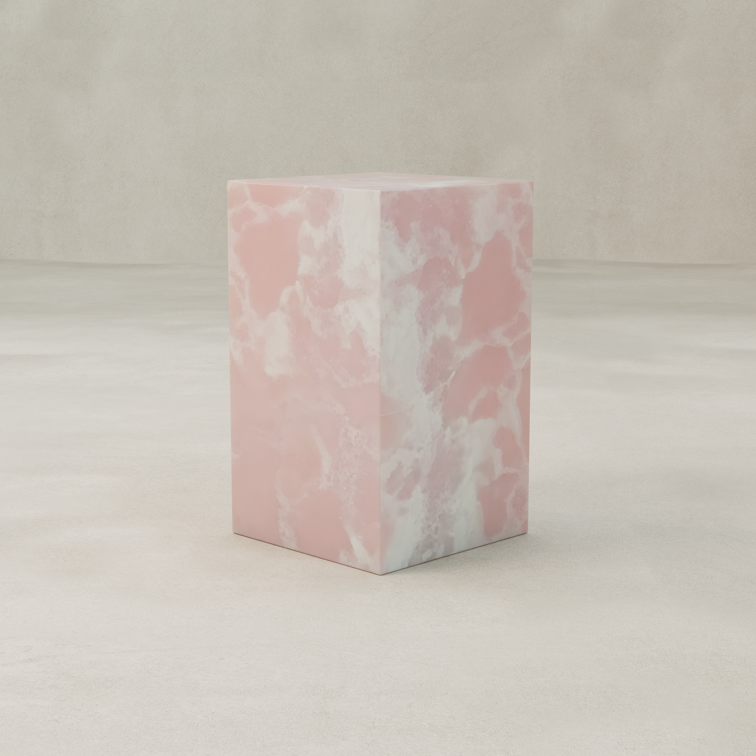 The Cora Tall Plinth, featuring a pink and white marbled texture inspired by Pink Onyx designs, stands on a smooth light beige floor with a matching beige background.