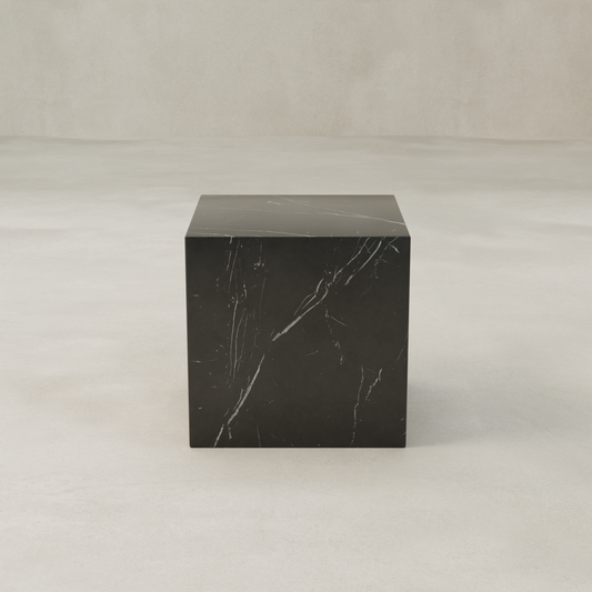 The Obscara Nero Marquina Marble Plinth - Cube features striking black marble with subtle white veining, standing elegantly on a smooth surface against a neutral backdrop for a look of timeless sophistication.