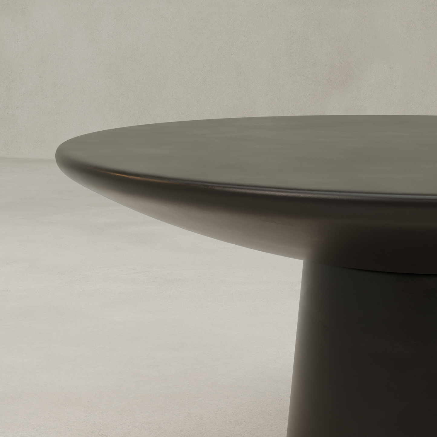 A close-up of the Arrio Table, featuring a thick circular top and sturdy central pedestal base, set against a neutral light gray background.