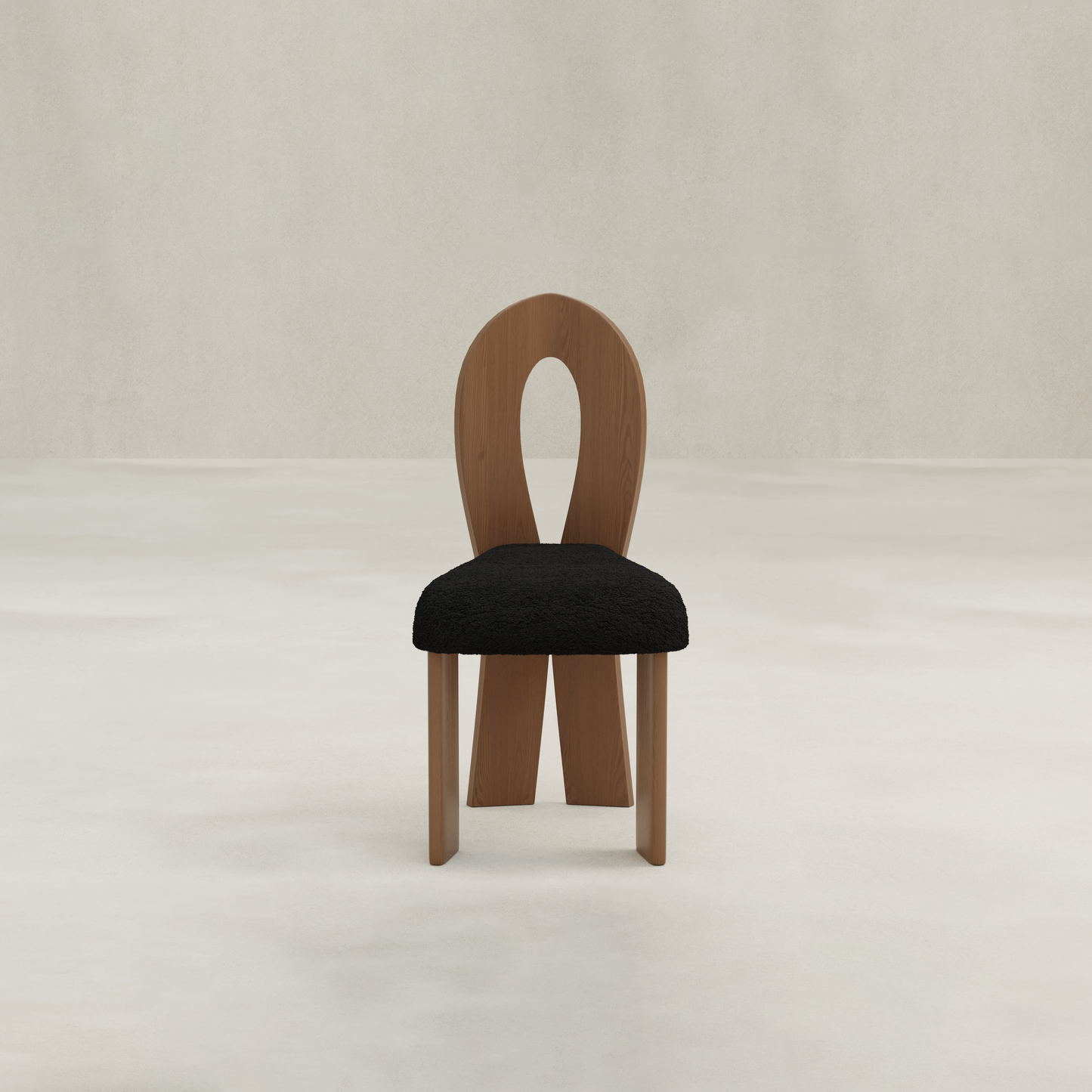 The Aveline Dining Chair features a unique looped backrest and a black cushioned seat, offering modern elegance and comfort for your dining space.
