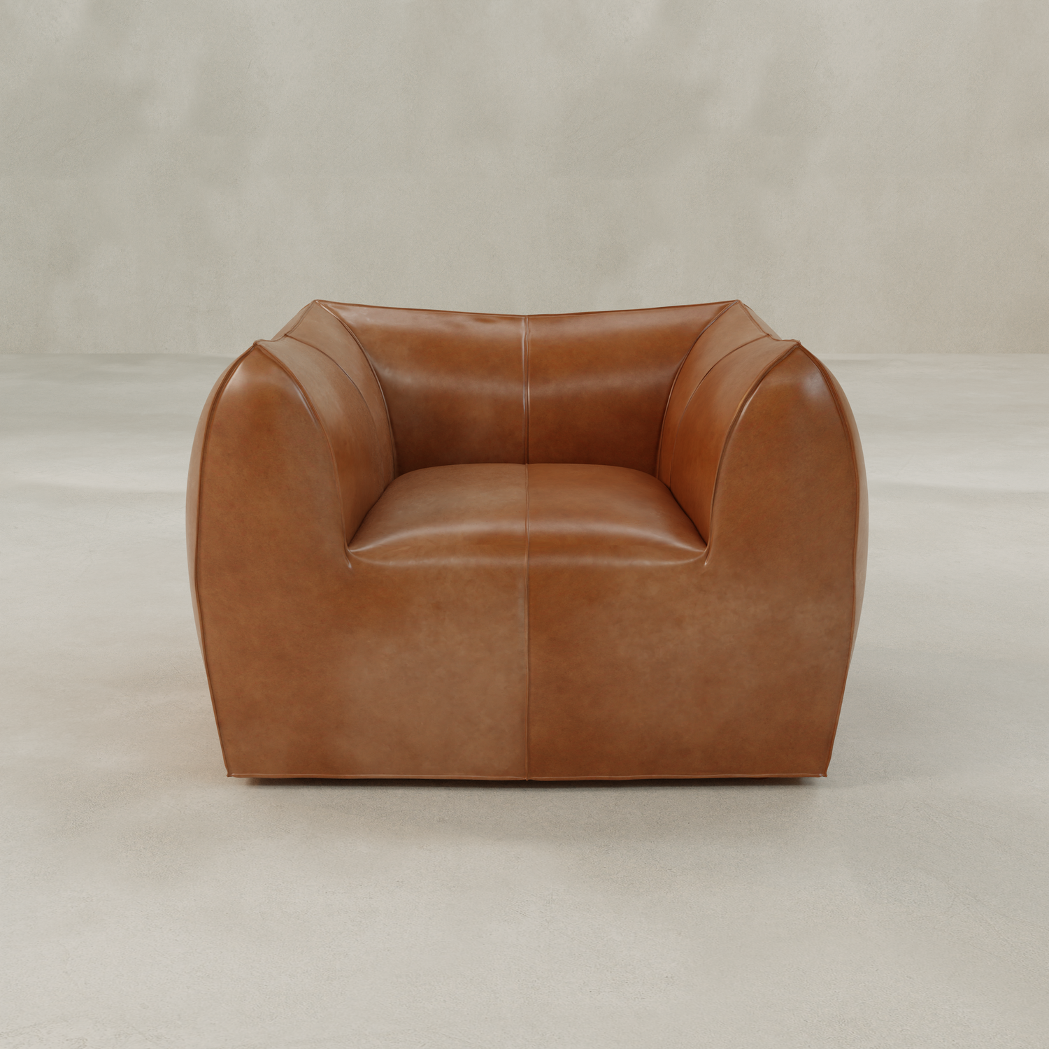 The Bambon Armchair, featuring a modern boxy design and smooth vintage leather upholstery, sits on a neutral light-colored floor against a plain, light gray background.