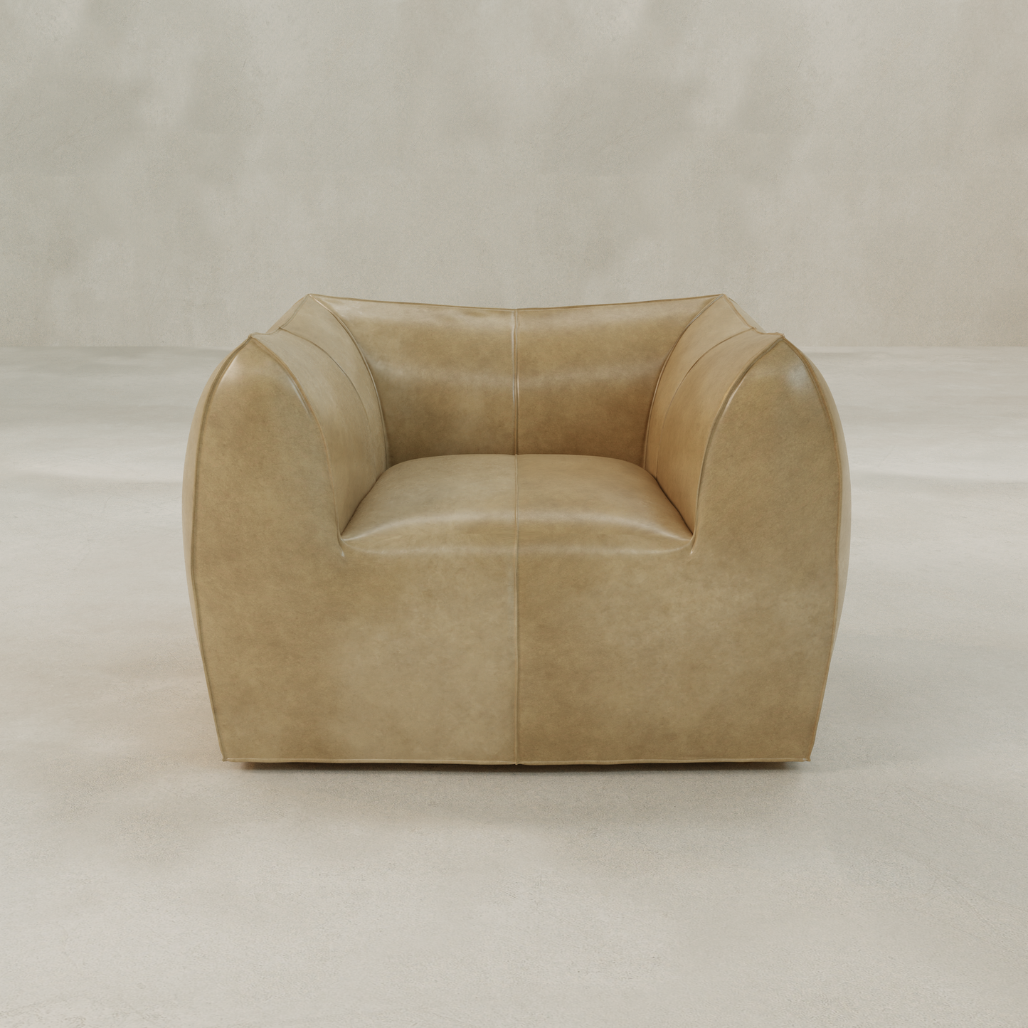 The Bambon Armchair features vintage leather upholstery, a wide seat, and curved cushioned sides and back, set against a light neutral floor and background.