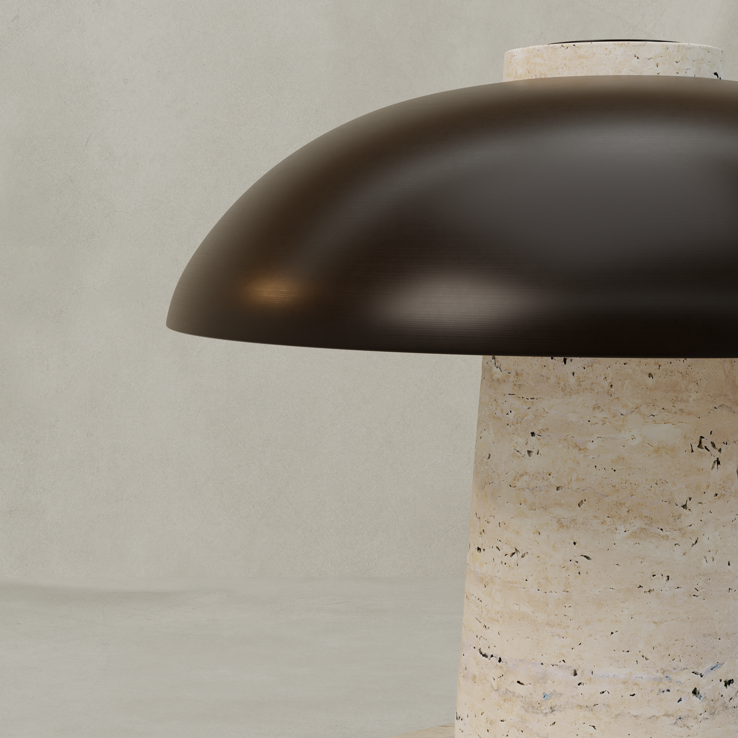 A close-up of the Chiara Lamp, showcasing its dark, dome-shaped metal shade and cylindrical beige travertine base against a plain light gray background.