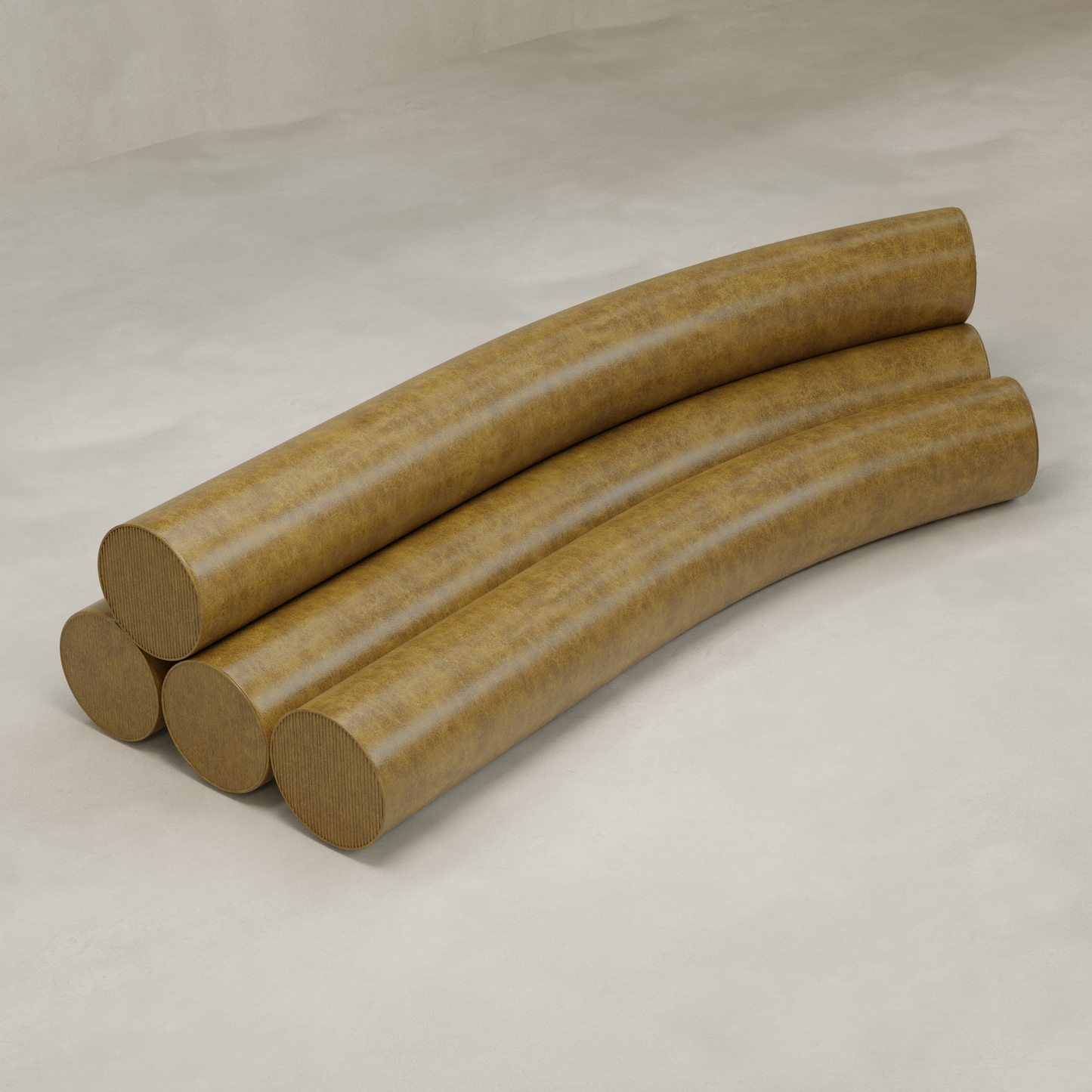 Four large, curved, tan-brown pieces are stacked on a plain floor, forming a minimalist arrangement that resembles the modern Cylindra Sofa.