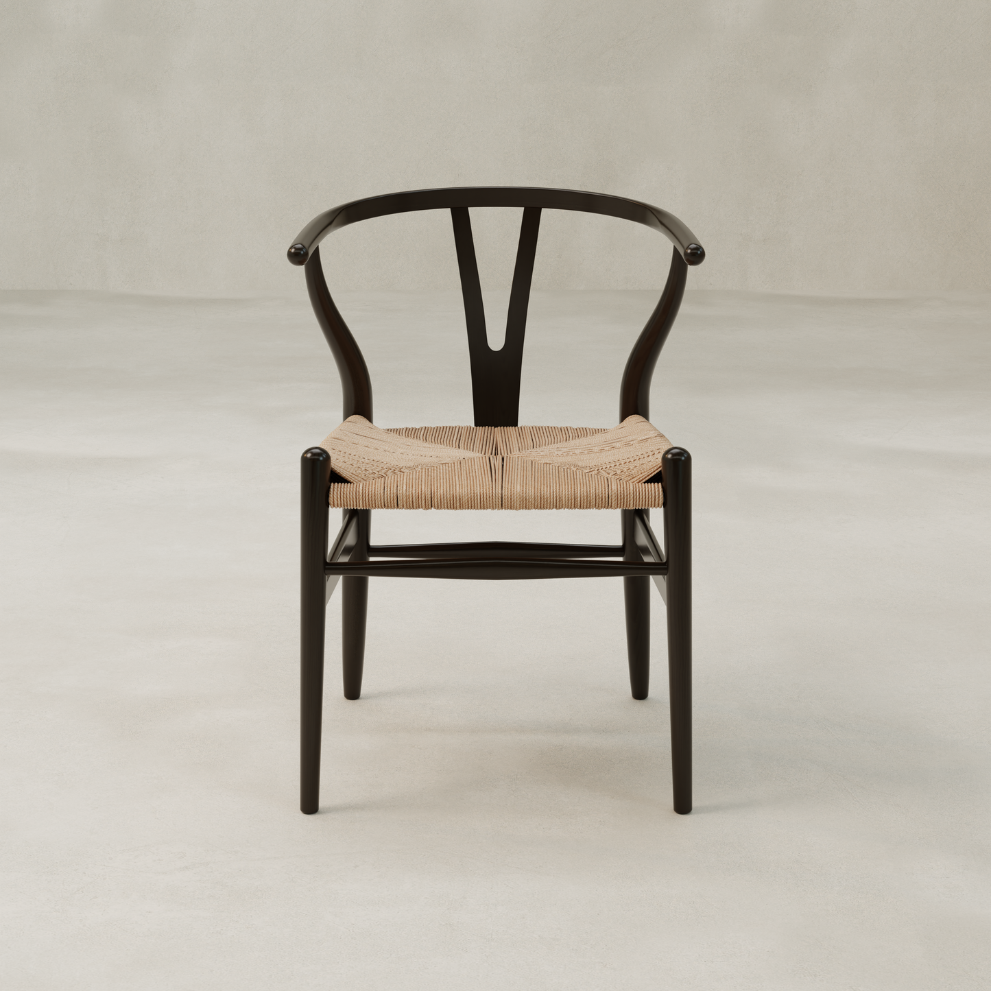 The Elsa Chair features a black wooden Y-back frame, curved backrest, and woven natural-colored seat, shown against a light background—ideal as a dining room chair beside a farmhouse dining table.