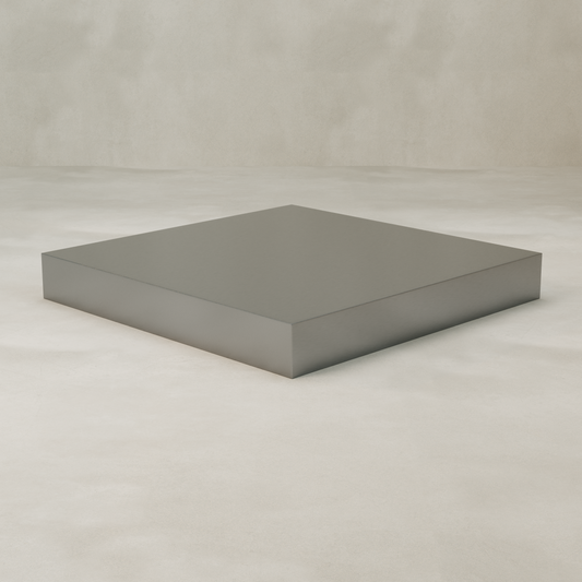The Forge Steel XL Square Plinth features a large, flat, square steel design with clean edges and a minimalist, industrial style. It sits on a light, smooth surface against a neutral background, adding modern flair to any space.
