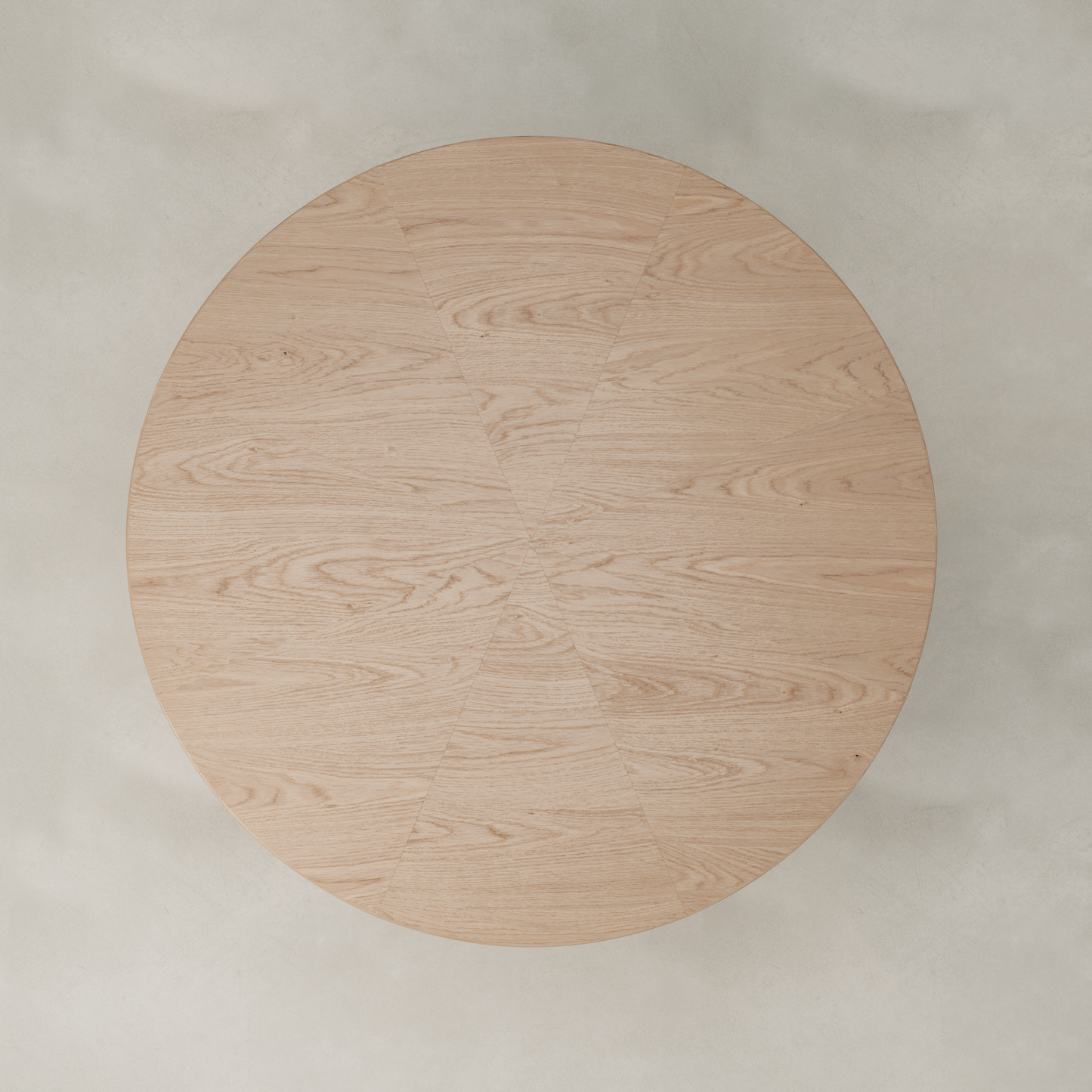 The Harlow Dining Table, featuring a light natural wood finish and subtle geometric sections in its wood grain, is viewed from above against a light, neutral background.