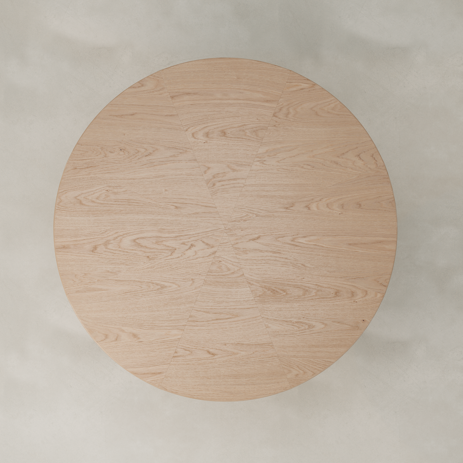 The Harlow Dining Table, featuring a light natural wood finish and subtle geometric sections in its wood grain, is viewed from above against a light, neutral background.