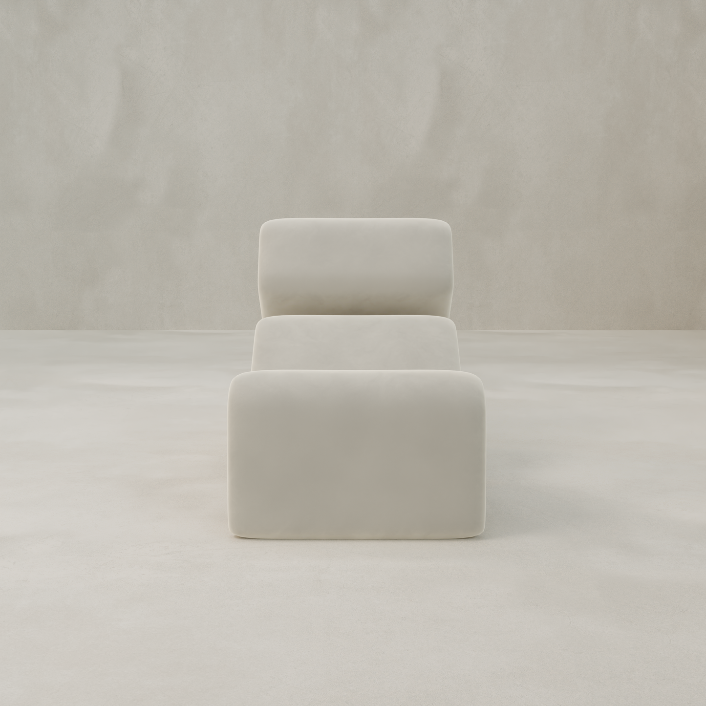 The Infinity Chaise Lounge, a modern white chair with smooth, rounded edges and velvet upholstery, features clean lines and a soft, cushioned look. It sits centered against a light, textured background for a minimalist feel.