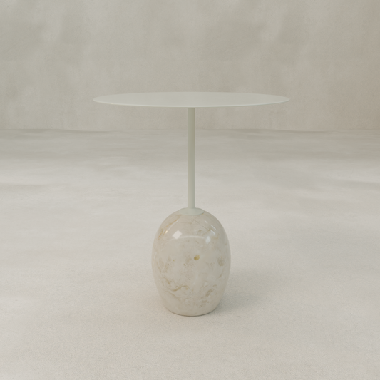 The Le Folie Table Crema Short features a slim, white round tabletop supported by a single stone leg on a glossy, marble-like oval base. Set against a neutral, minimal background.