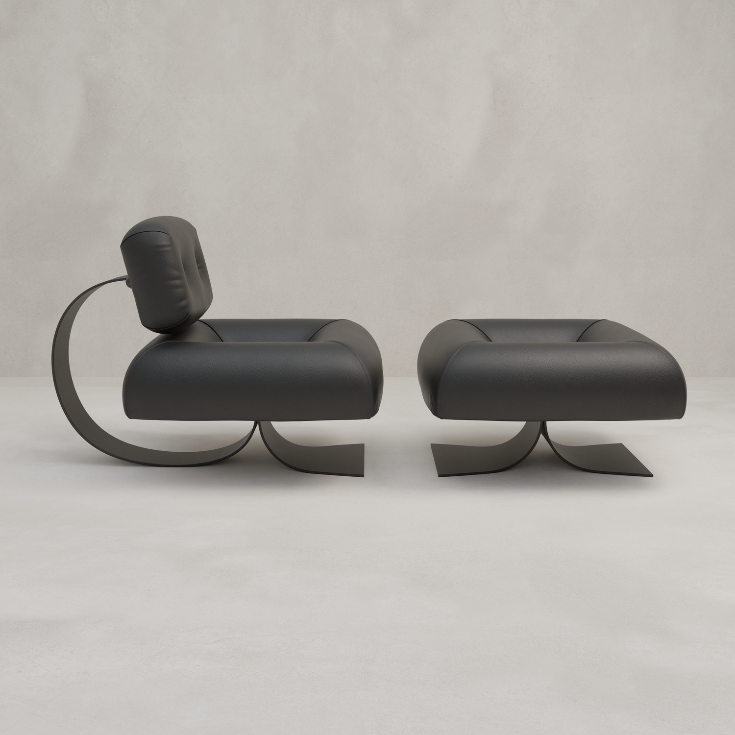 The Paolo Chair With Ottoman, featuring modern black leather and curved metal bases, adds contemporary style to the room against a light gray textured wall and floor.