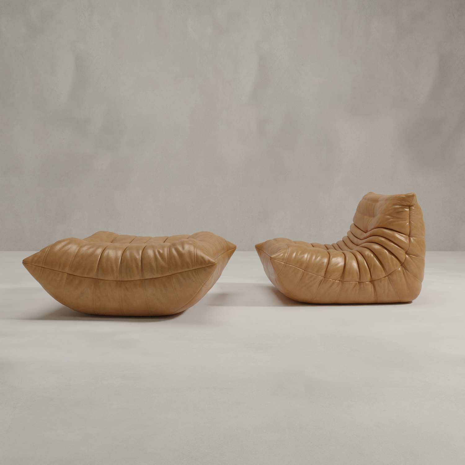 The Rolo Lounge Sofa Chair with Ottoman, featuring modern tan leather and deep tufting, sits on a light floor against a pale wall; the 70s-inspired chair has a high backrest, while the ottoman offers versatile seating.