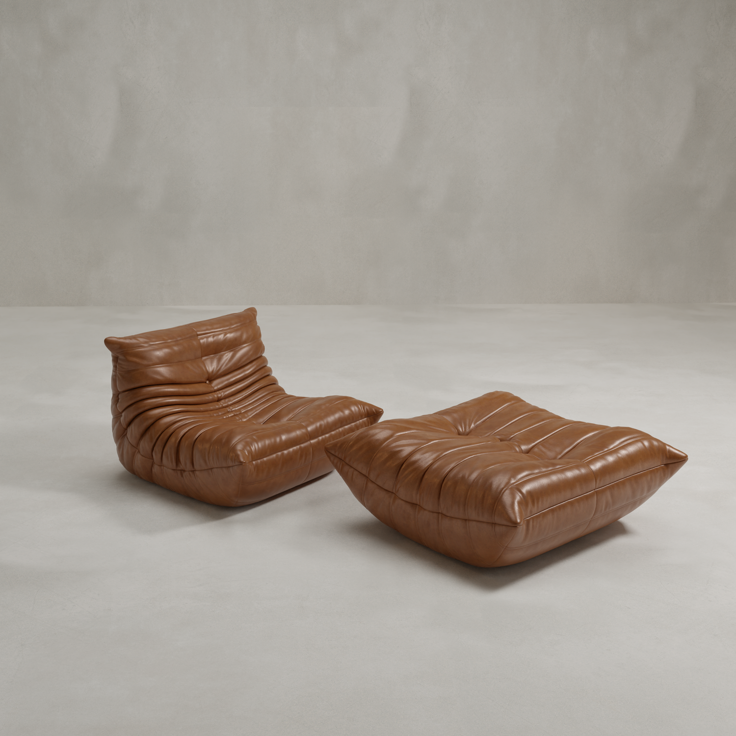 The Rolo Lounge Sofa Chair with Ottoman, featuring deep tufted brown leather in a modern mid-century style, sits on a smooth light gray floor against a plain textured gray wall.