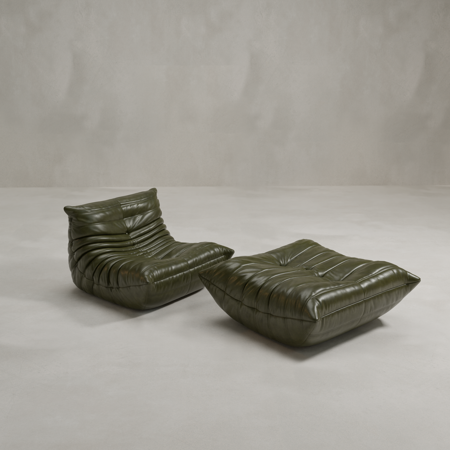 The Rolo Lounge Sofa Chair with Ottoman features deep, ruched dark green leather cushions in a 70s-inspired design, set against a plain light grey background.