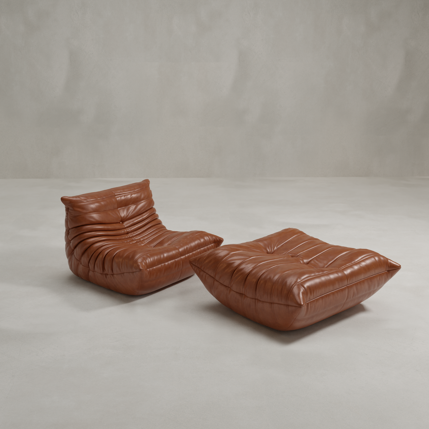 The Rolo Lounge Sofa Chair with Ottoman is a modern brown leather set, featuring deep plush cushioning and a low, armless mid-century design, displayed against a plain light gray background.