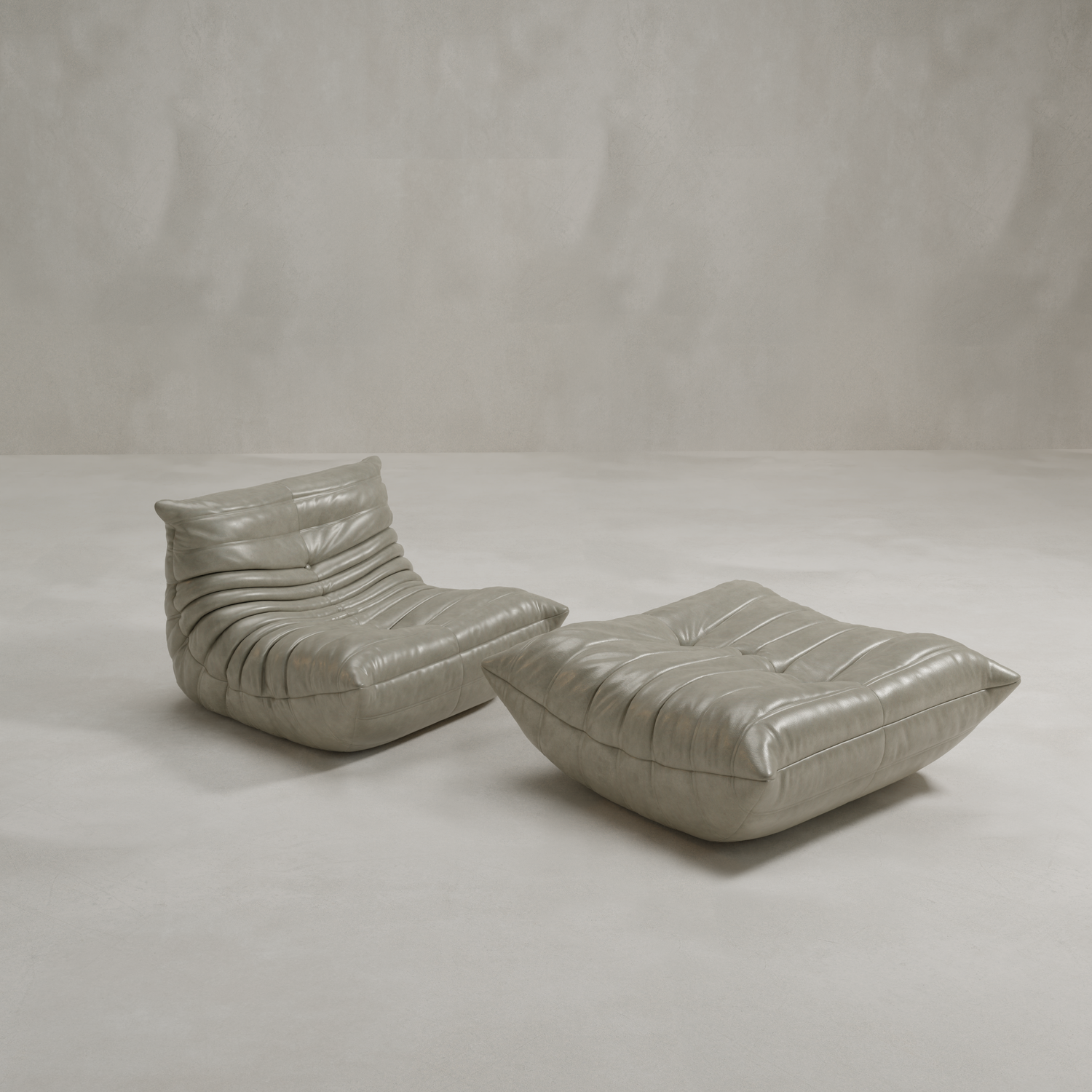 The Rolo Lounge Sofa Chair with Ottoman features a modern 70s-inspired low-profile design in soft gray leather, highlighted by tufted, cushioned details and set against a minimalist light gray background.