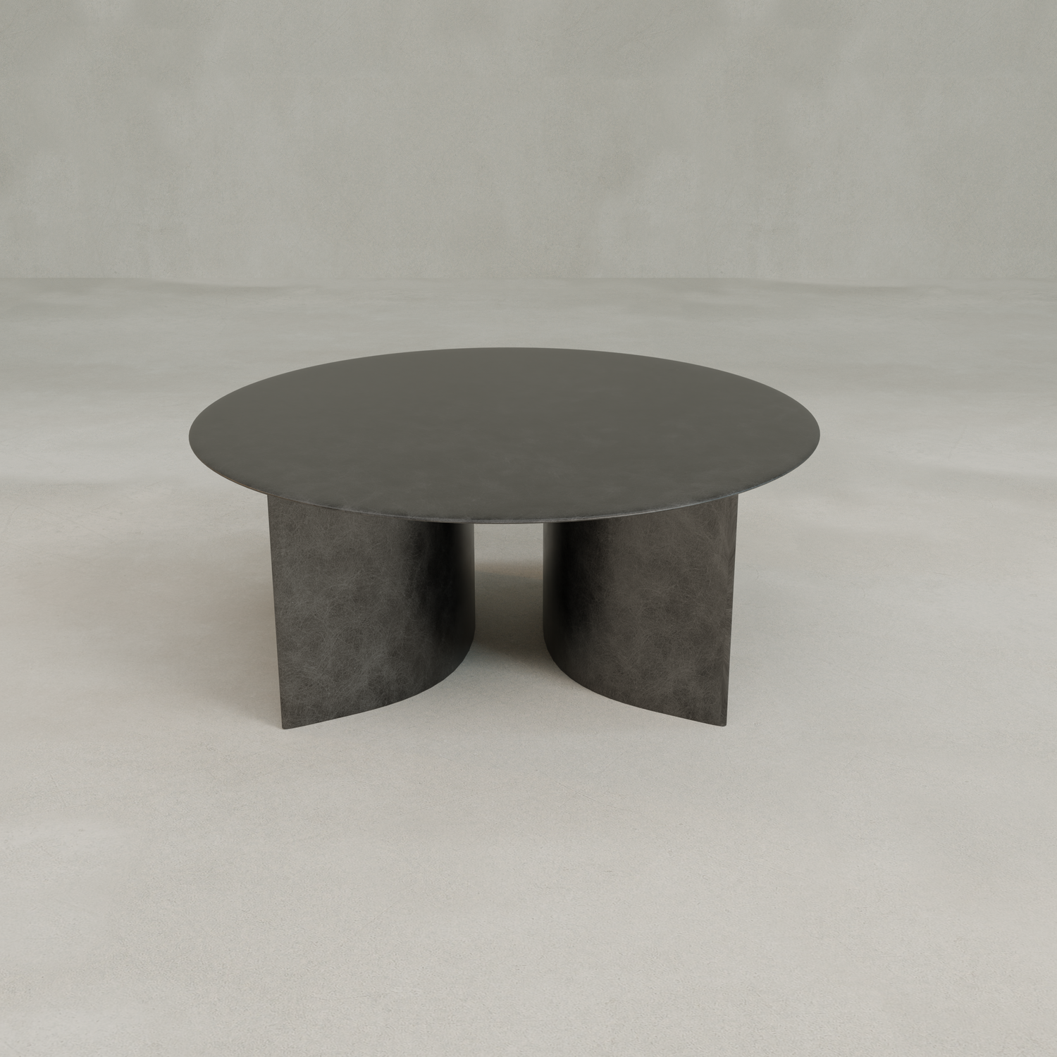 The Roma Coffee Table Large is a modern, round black table with an elegant flat top and two curved pedestal legs, set against a light, minimalist background.