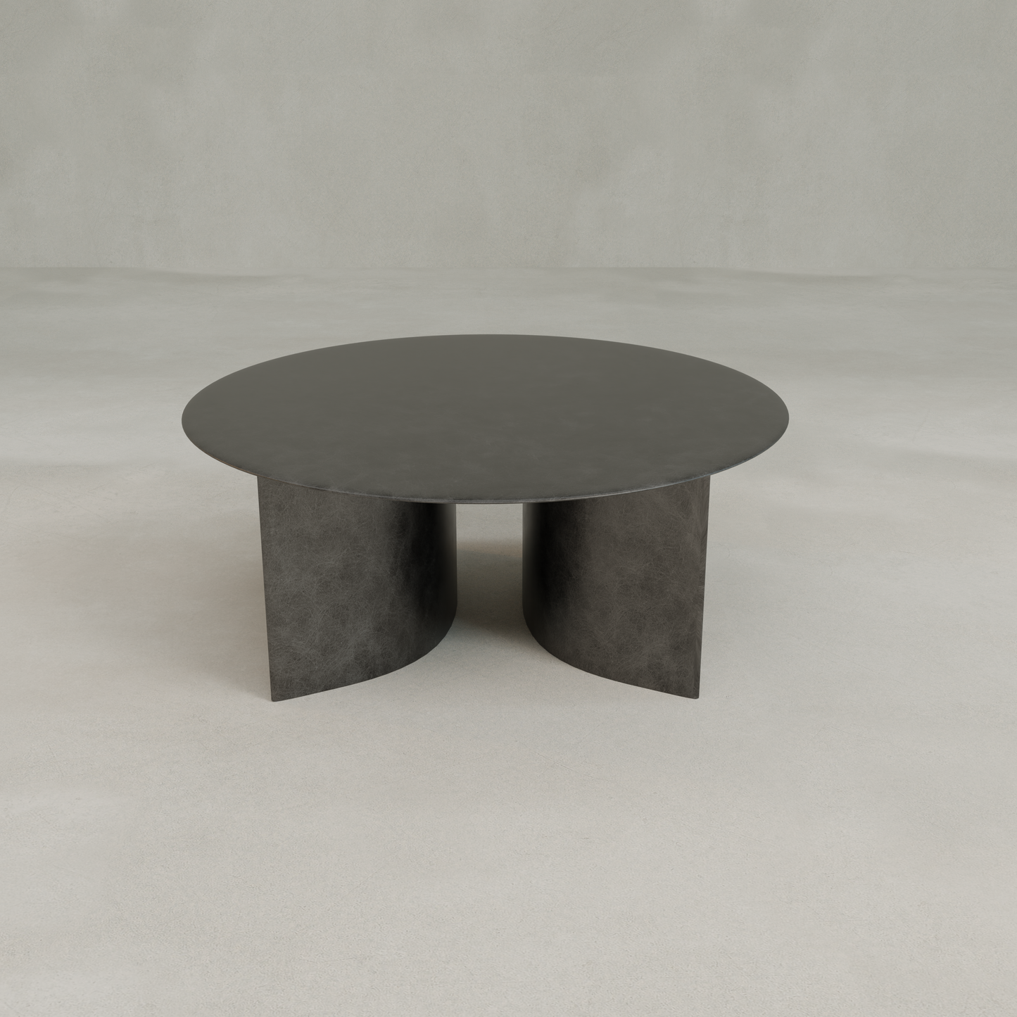 The Roma Coffee Table Large showcases a modern, round silhouette with a dark finish and two intersecting curved panel legs, elegantly contrasted against a light, neutral background.