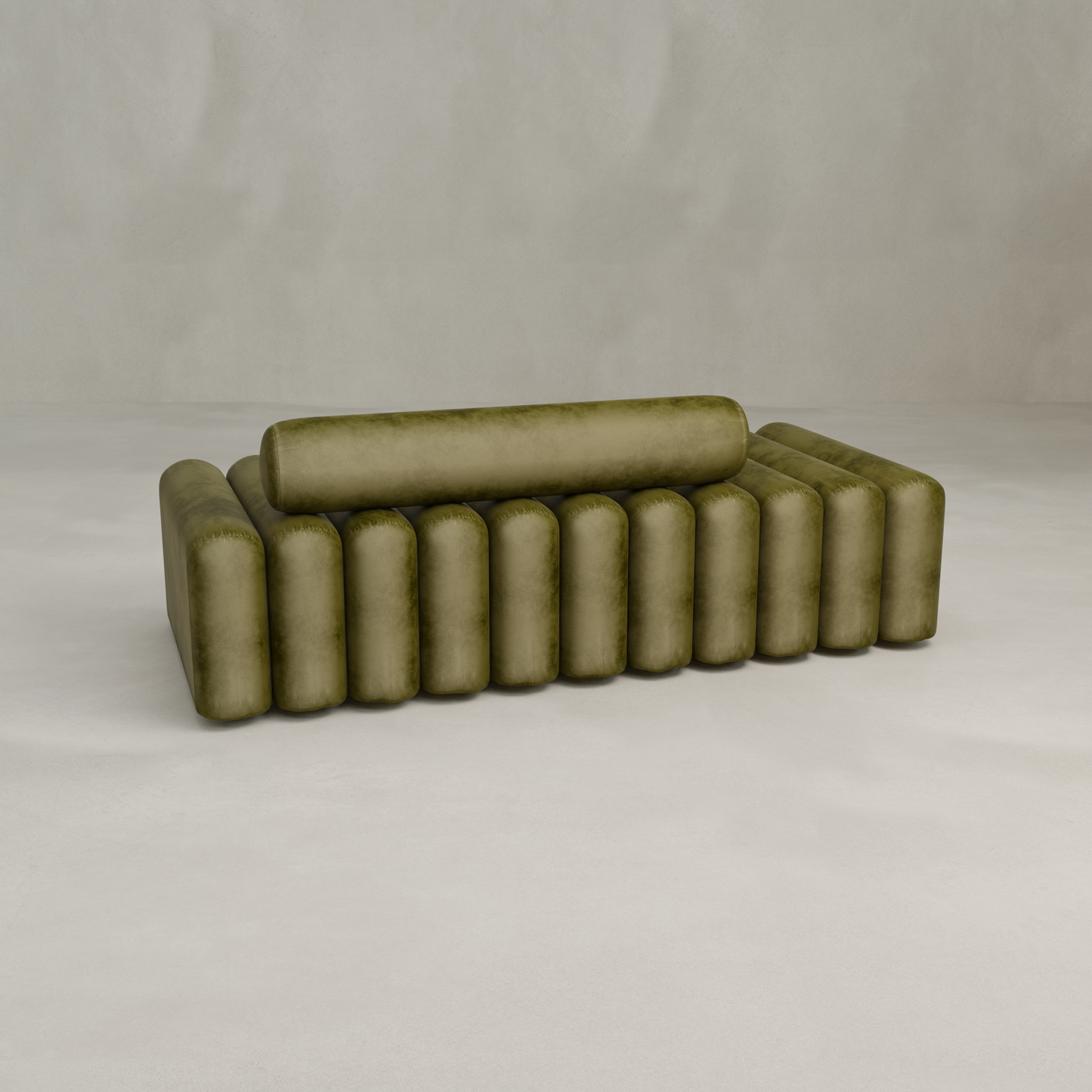 The Sonorra Bench Large is a modern olive green velvet piece with quilted upholstery and a cylindrical backrest featuring vertical, evenly spaced cushioning, set against a light, minimal background.