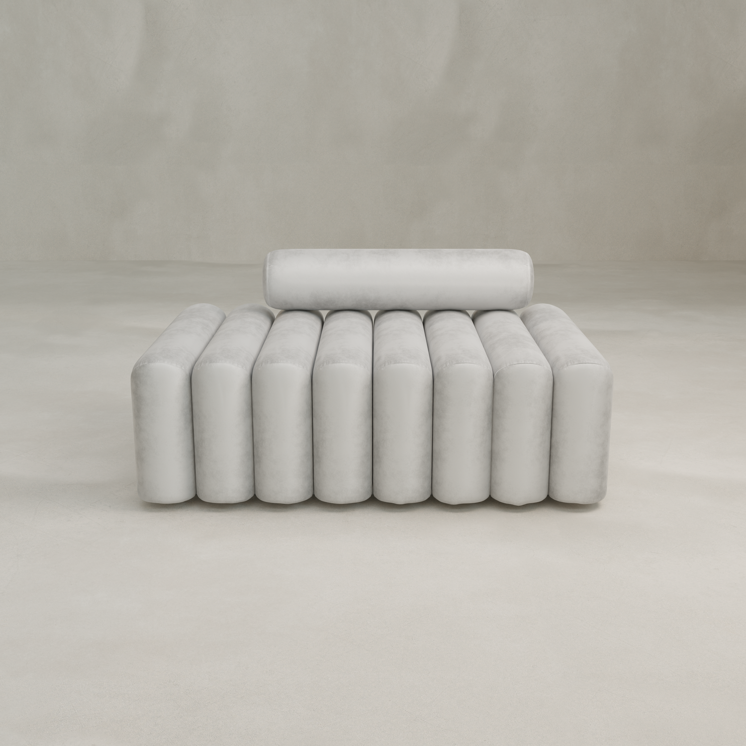 The Sonorra Bench Medium features a modern, minimalist design with cylindrical backrest and seat, plush light gray upholstery, set against a plain light beige background.