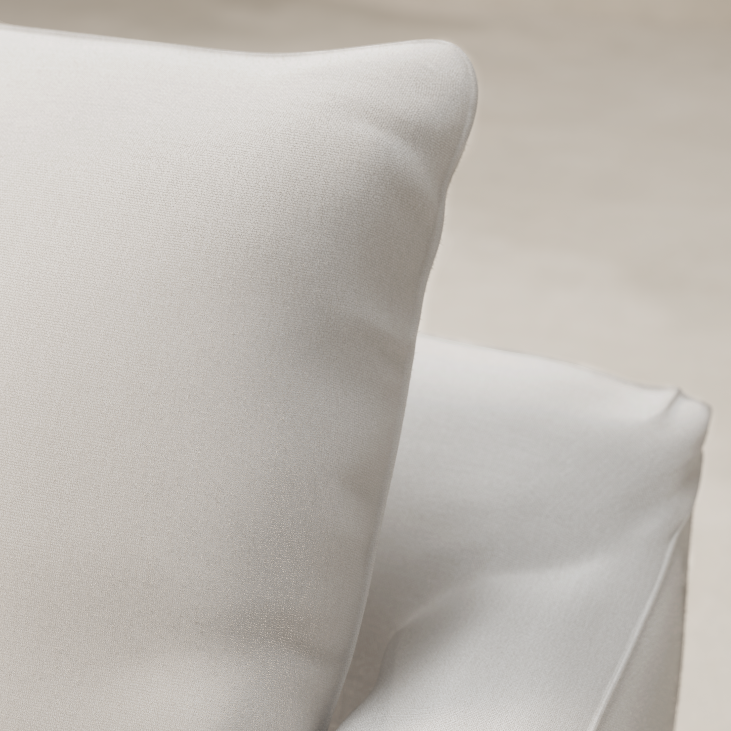 Close-up of two soft white fabric cushions with a smooth texture, placed on the Woolsey Sofa in natural-toned fabric against a neutral background.
