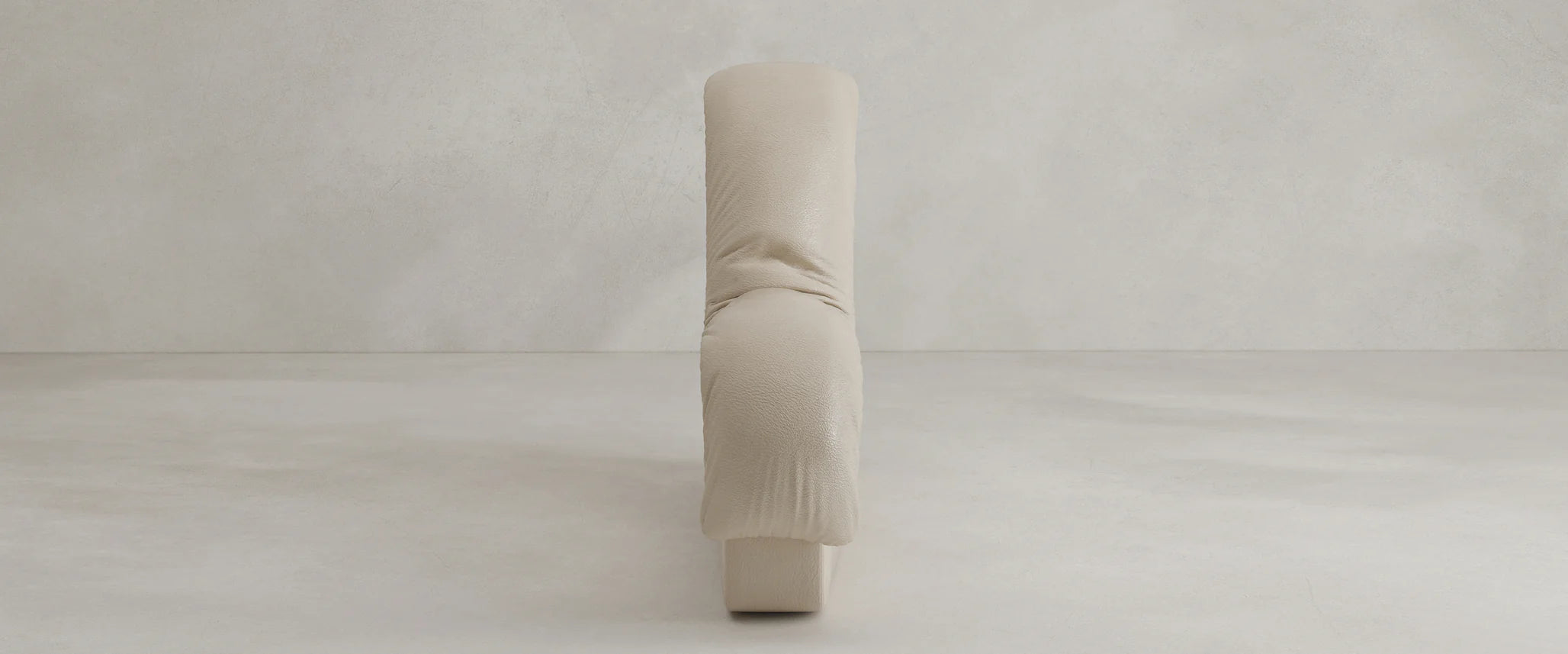The Serpenti Sofa Armrest Module is a modern, minimalist piece upholstered in light beige leather with soft, rounded edges and a plush, sculptural design inspired by modular sofas for versatile comfort. Shown from the front against a plain background.