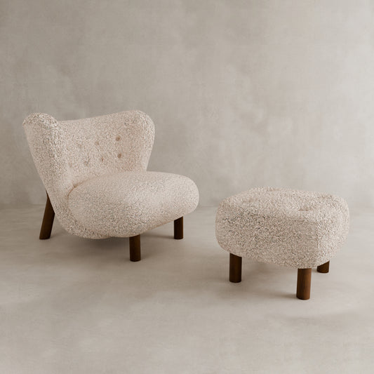 The Highgate Chair With Ottoman features a modern curved design in cream boucle vegan shearling with button tufting, both resting on a neutral floor against a plain background.