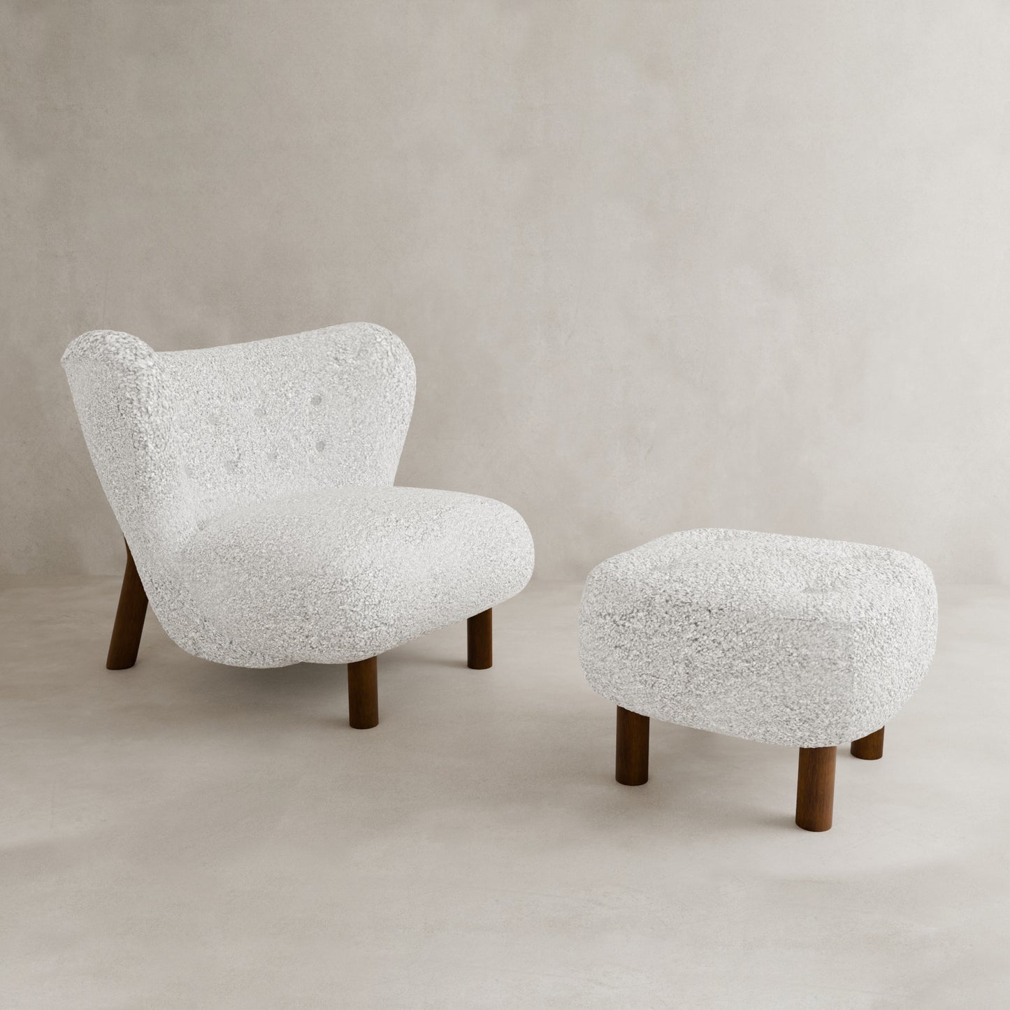 The Highgate Chair With Ottoman features a modern white curved design with vegan shearling upholstery and button tufting, making it a striking contemporary statement piece against a neutral, light-colored background.