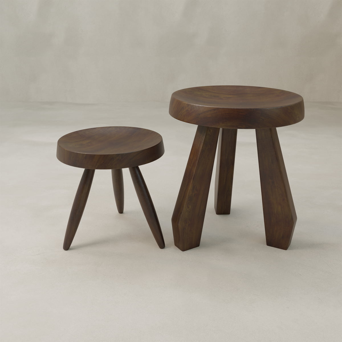 The Amara Tall Stool features a minimalist, modern design with a hand-carved round seat and tripod base in a dark solid wood finish, shown against a light, neutral background.