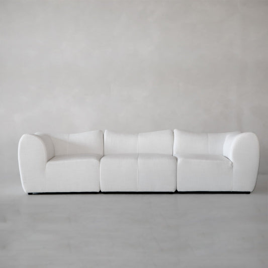 The Bambon 3 Piece Sofa Set features plush cushions and rounded arms, upholstered in white fabric for a contemporary look, shown here against a plain light grey background.