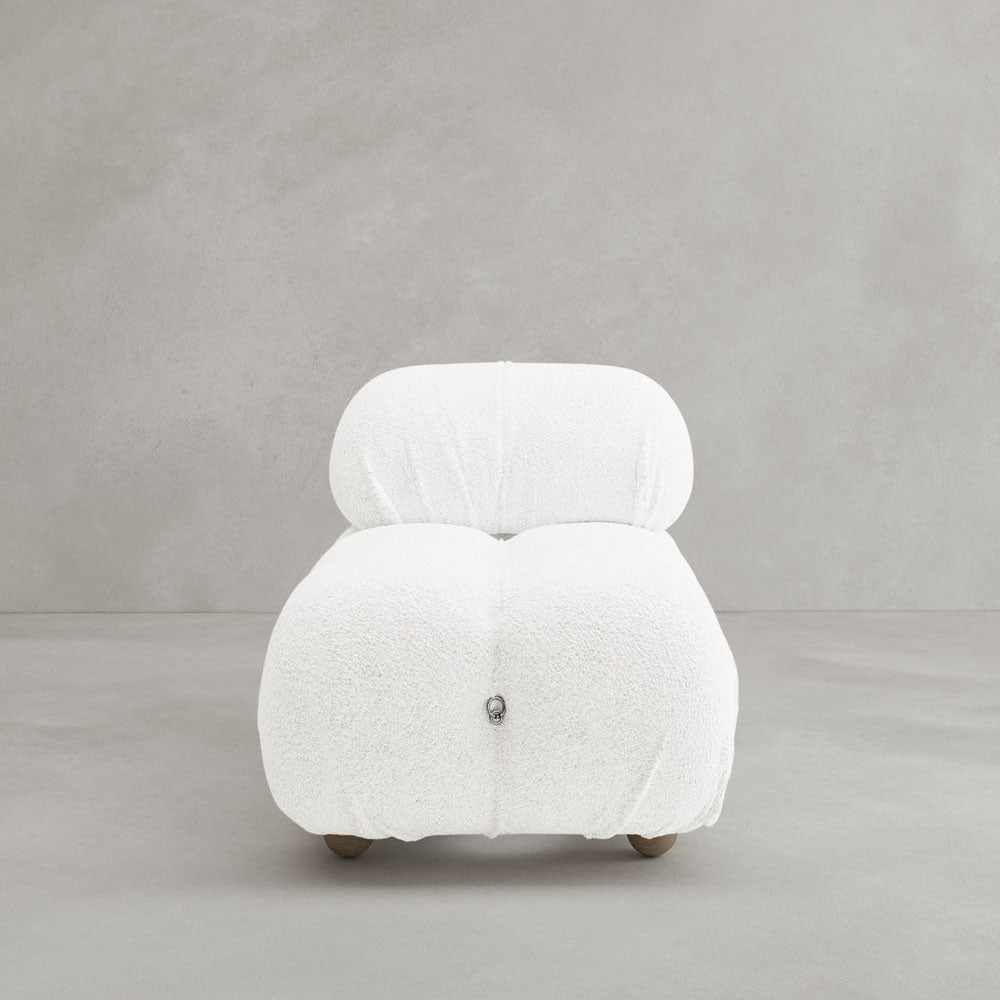 The Belmont Chair 2/3Rd Modular Sectional features a modern, armless design with white textured upholstery, marshmallow-like curves, and a plush rounded backrest on subtle wooden feet, set against a smooth light gray background.