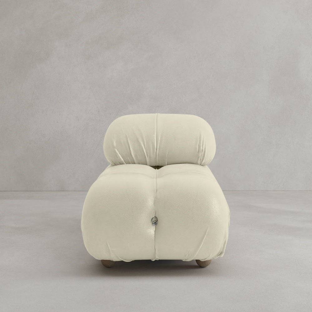The Belmont Chair 2/3Rd Modular Sectional features modern, marshmallow-like curves and overstuffed cream-colored upholstery with visible tufting, set against a plain light gray background for a cozy, plush appeal.