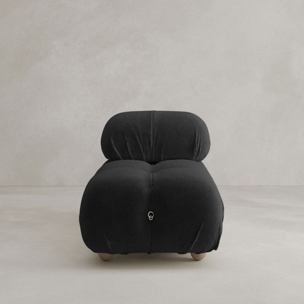 The Belmont Chair 2/3Rd Modular Sectional features a modern, low-profile design in black with plush, marshmallow-like curves, set against a light, minimalist background.