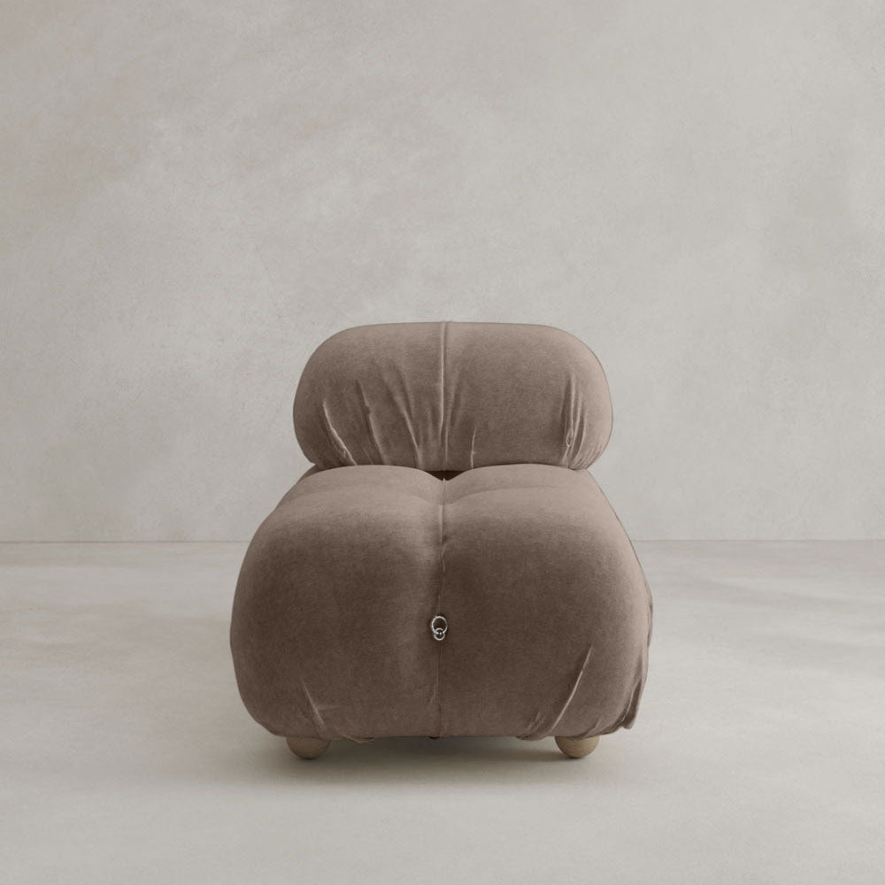 The Belmont Chair 2/3Rd Modular Sectional features plush, rounded cushions and soft taupe upholstery, creating a cloud-like look as it sits armless on a light gray floor against a simple light wall.