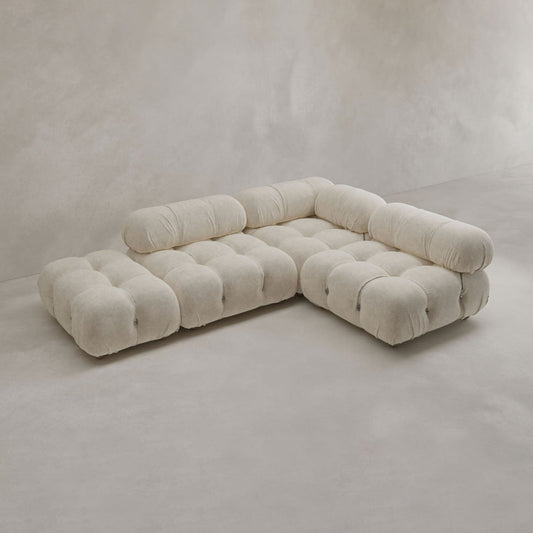 The Belmont Sofa Combination B, a modern modular cloud sofa in cream with tufted cushions and a low-profile design, sits against a neutral, minimalist background.