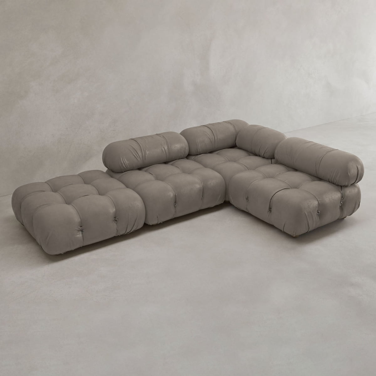 The Belmont Sofa Combination C features marshmallow-like curves, tufted plush cushions, and cylindrical headrests, all upholstered in light gray fabric and displayed against a plain light gray background.