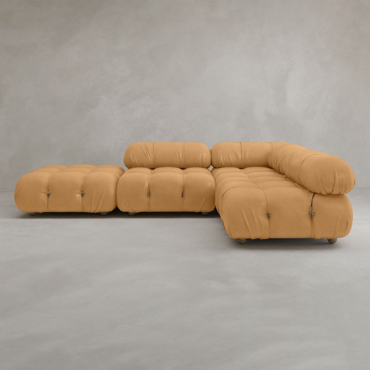 The Belmont Sofa Combination C features marshmallow-like curves and tufted cushions with rounded edges, shown in tan upholstery against a plain gray background.